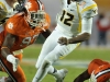 January 04 2011: Geno Smith #12 evaded Malliciah Goodman #97 and the rest of the Clemson defense during NCAA football Discover Orange Bowl between West Virginia and Clemson at Sun Life Stadium, Miami Florida.